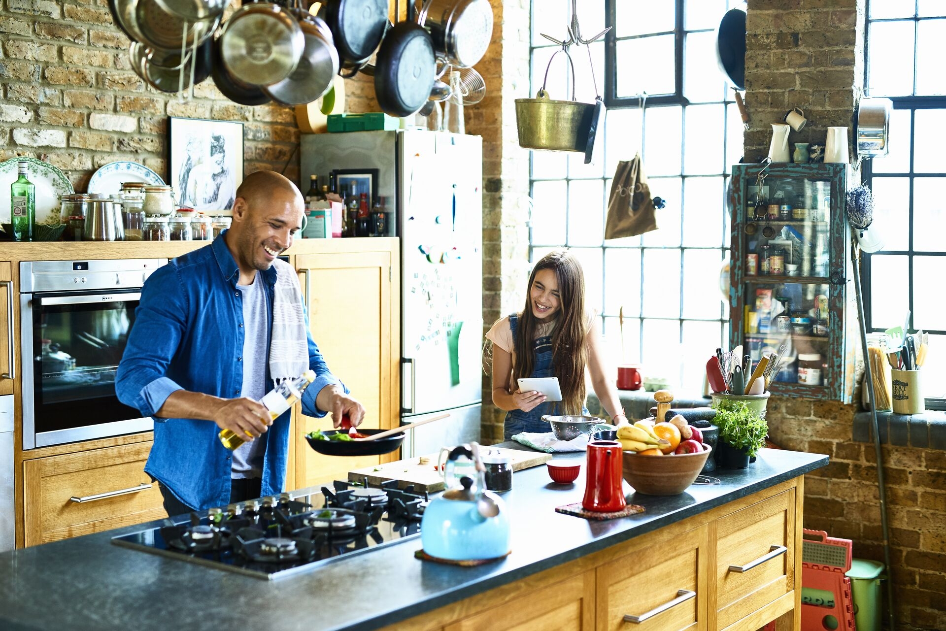 Dad and daughter cooking in kitchen