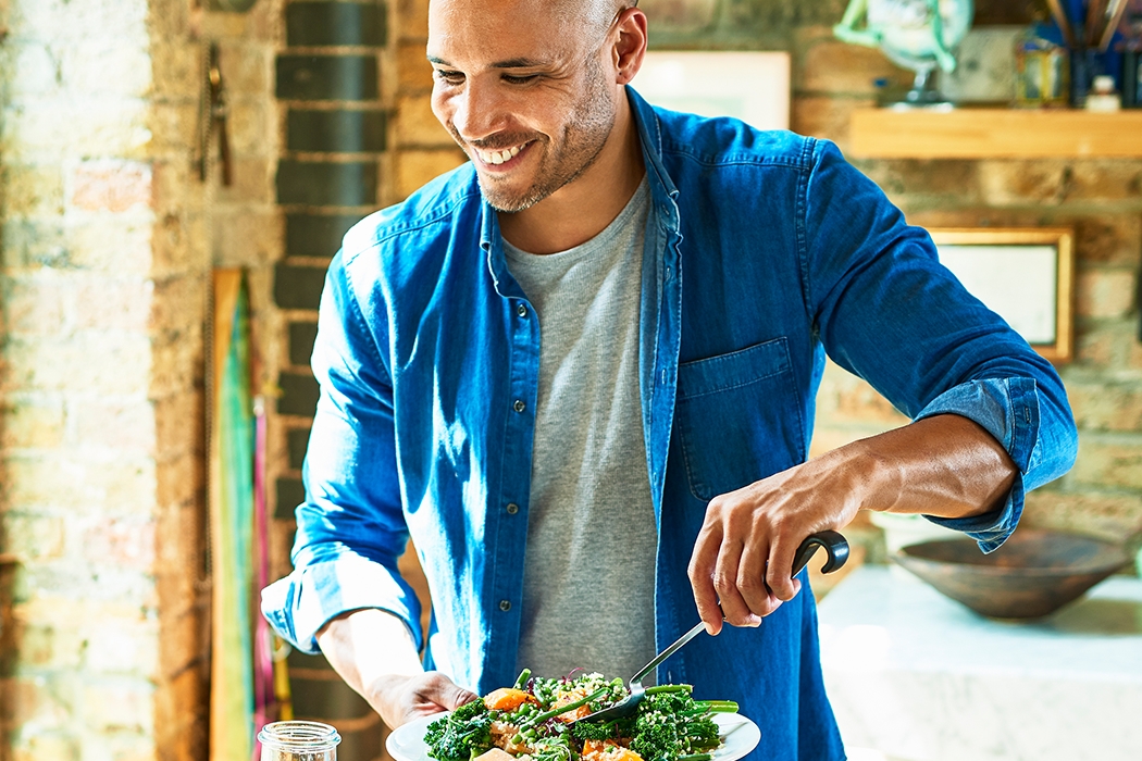 A man serving his family dinner