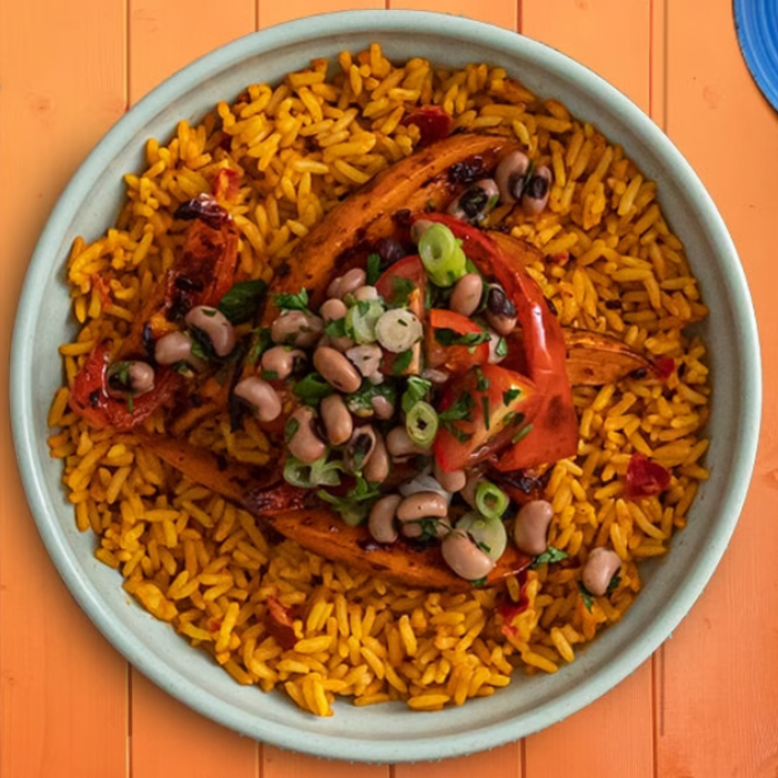 A bowl of rice with vegetables on a table